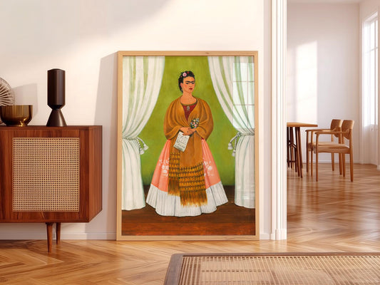 Frida Kahlo self-portrait art print featuring the artist in traditional Tehuana dress with green backdrop wall art.