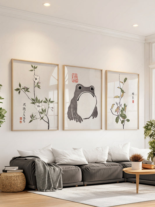 Matsumoto Hoji frog and botanical art print set of three displayed as Japanese-inspired wall art in a living room.