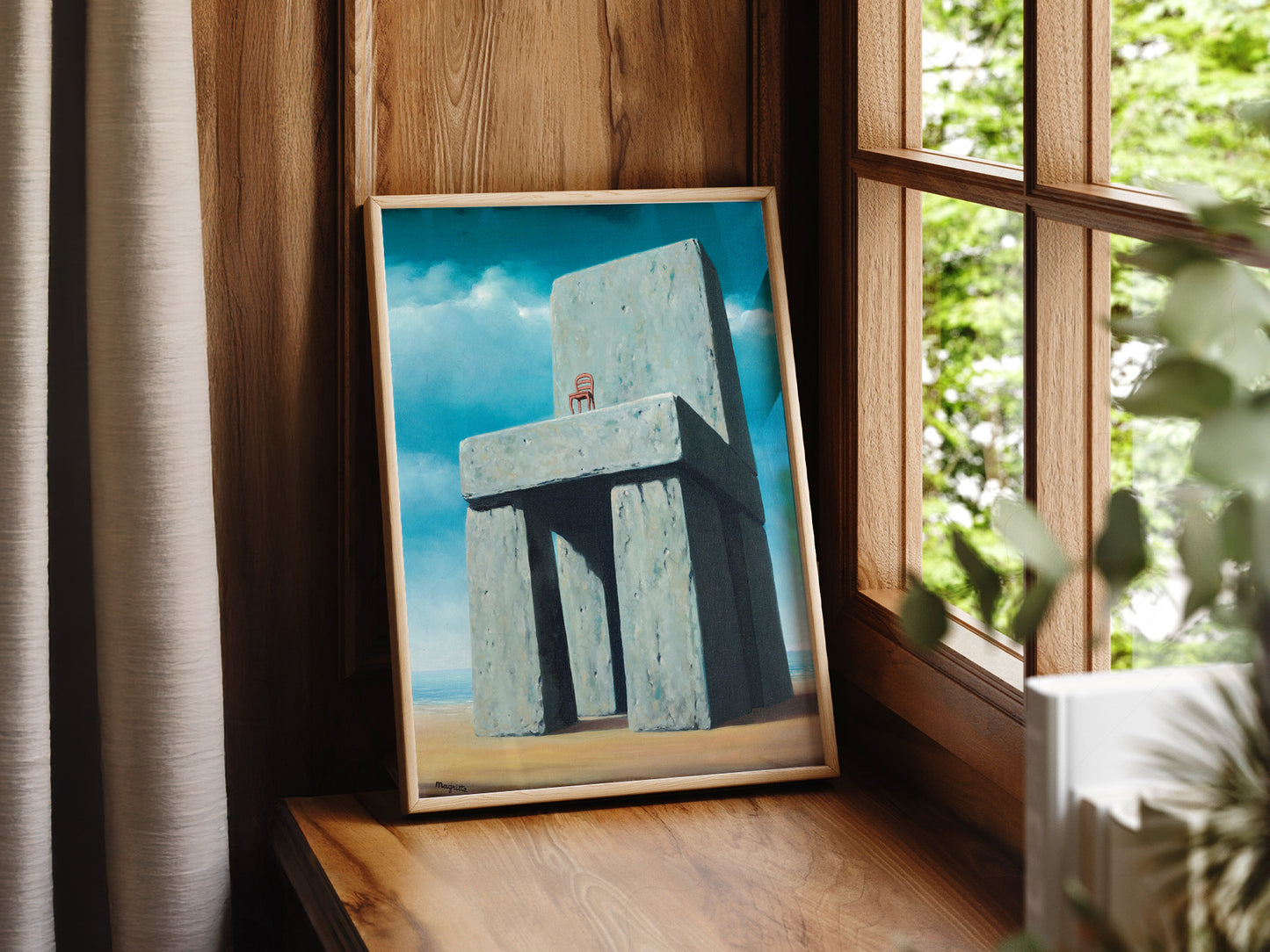 René Magritte art print as wall decor in a minimalist home office