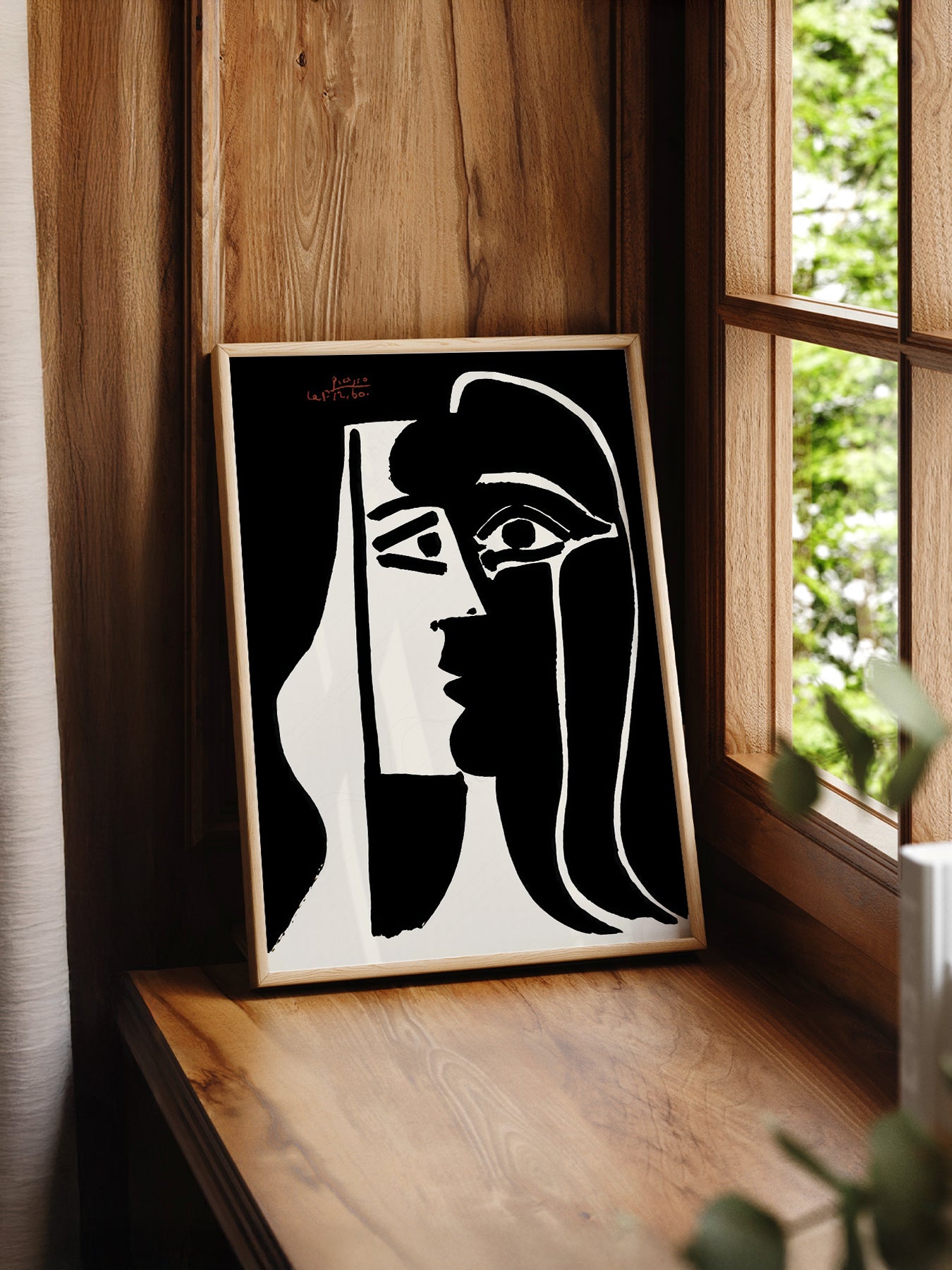 Pablo Picasso Two Faces print styled in a mid-century modern dining room