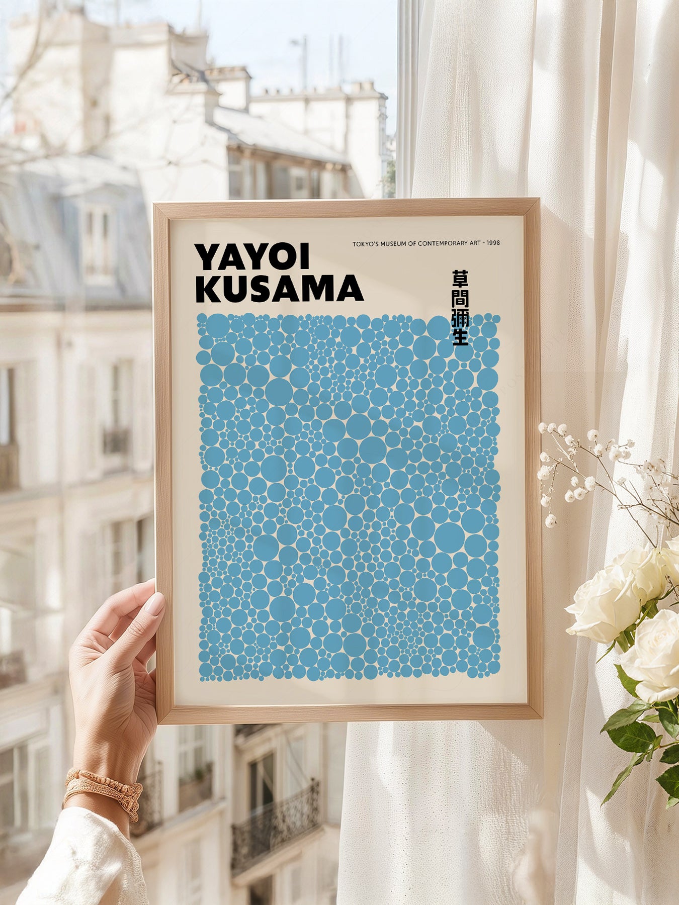Yayoi Kusama art print as wall decor in a minimalist home office