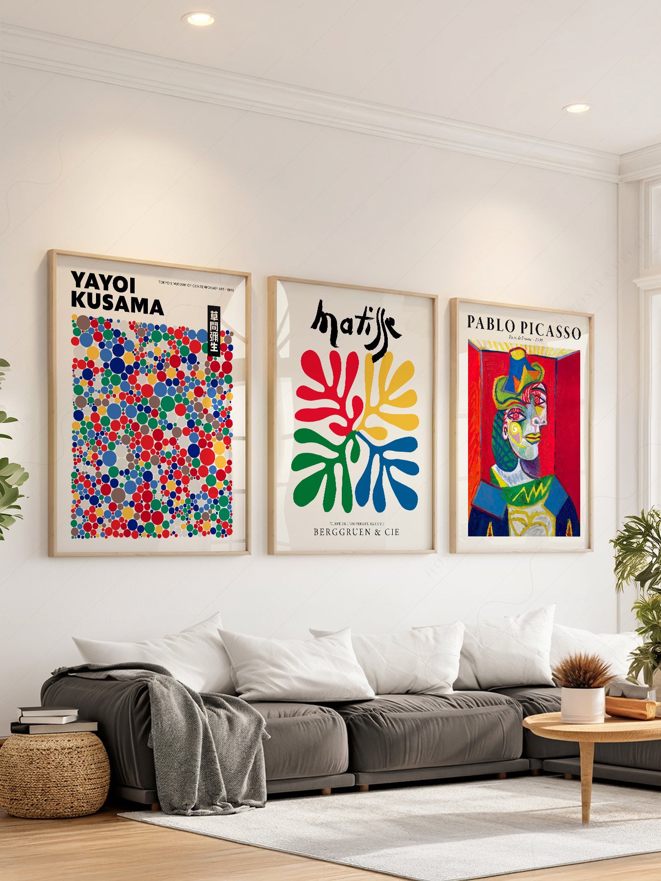 Set of three wall art prints featuring Yayoi Kusama dots, Henri Matisse cut-outs, and Pablo Picasso portrait in modern living room.