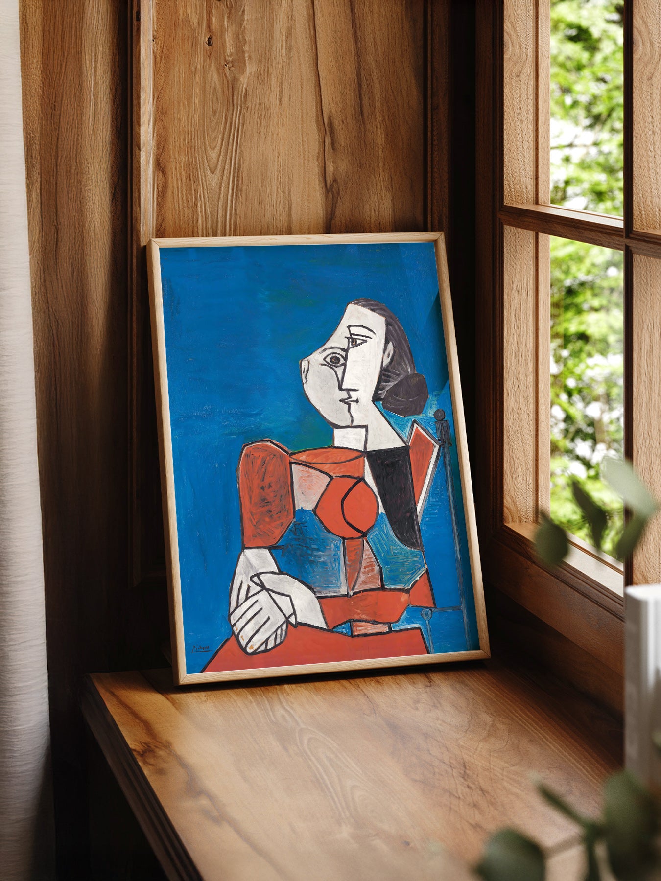 Pablo Picasso Femme Seated Woman print styled in a mid-century modern dining room