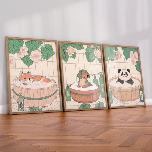 A set of three vertical art prints featuring animals in a spa setting. The left print shows a red fox sleeping in a wooden tub with pink petals. The middle print features a dachshund in a bubble bath with green bottles. The right print shows a panda cub soaking in bubbles under large green leaves.