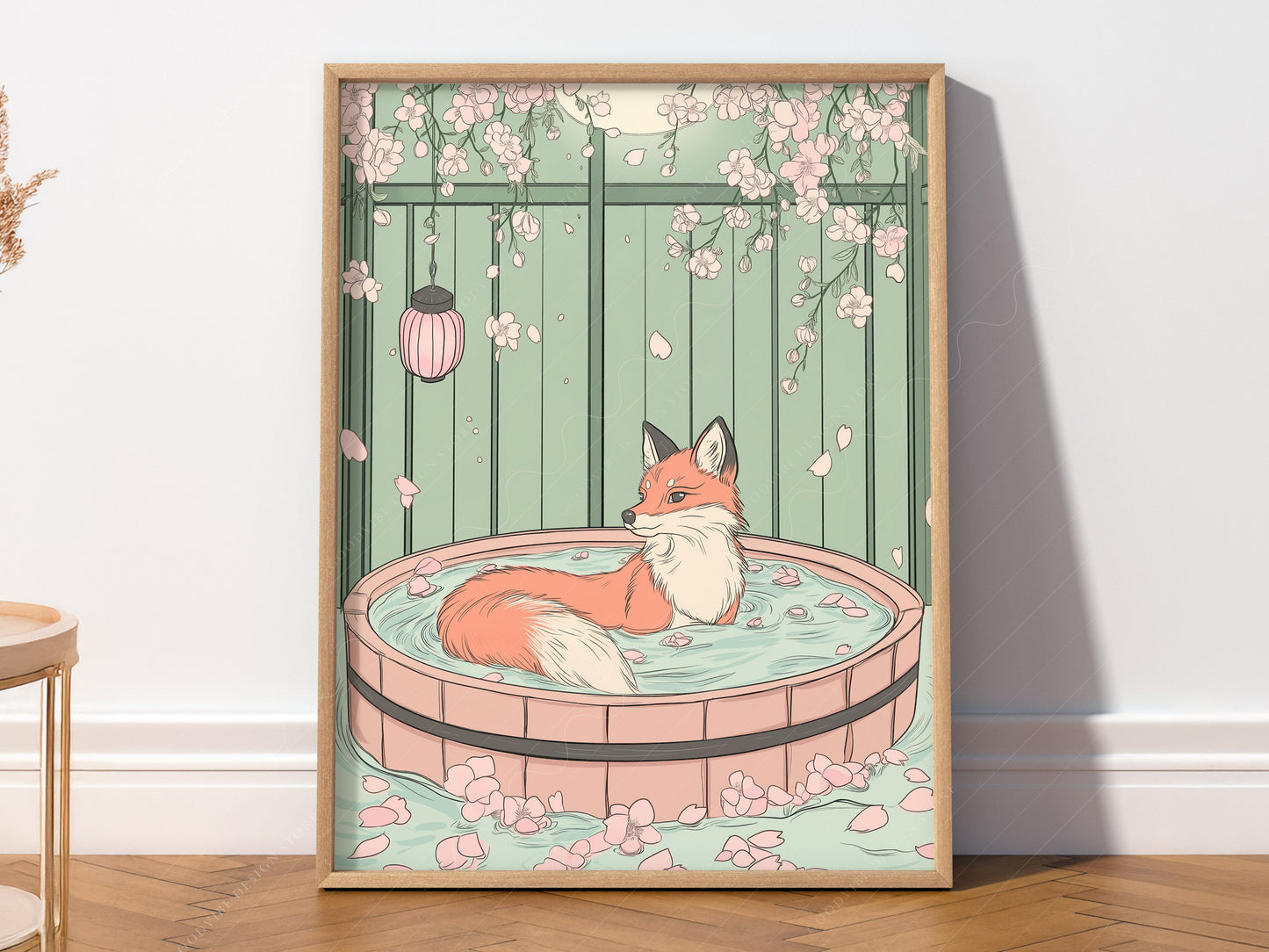 A vertical art print featuring a red fox with a white-tipped tail sitting in a circular wooden bath tub filled with water and pink petals. The background is a pale green fence with pink cherry blossoms hanging from the top and a pink lantern to the left. The scene is calm and illustrative with soft pastel colors.