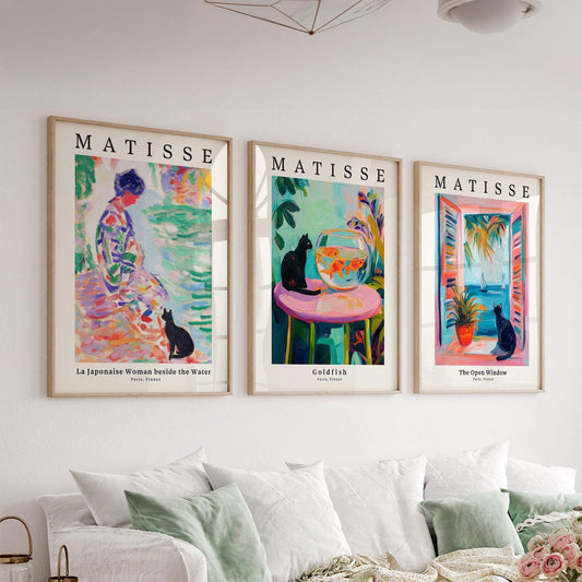 Matisse-inspired black cat art print set of 3 featuring colorful compositions displayed as wall art above a sofa.