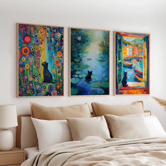 Set of three black cat art prints inspired by famous paintings displayed as colorful wall art above a bed.