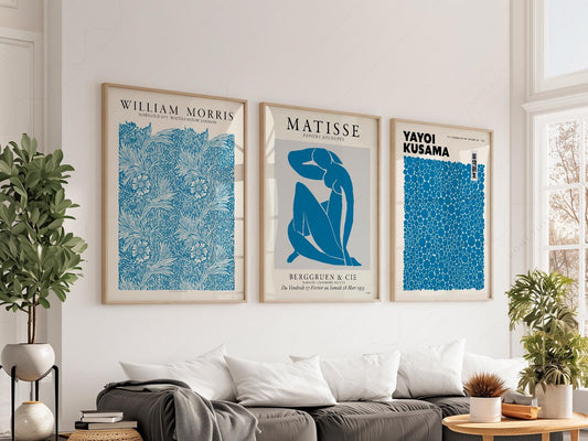 Blue gallery wall art set featuring William Morris, Matisse, and Yayoi Kusama exhibition posters in a modern living room.