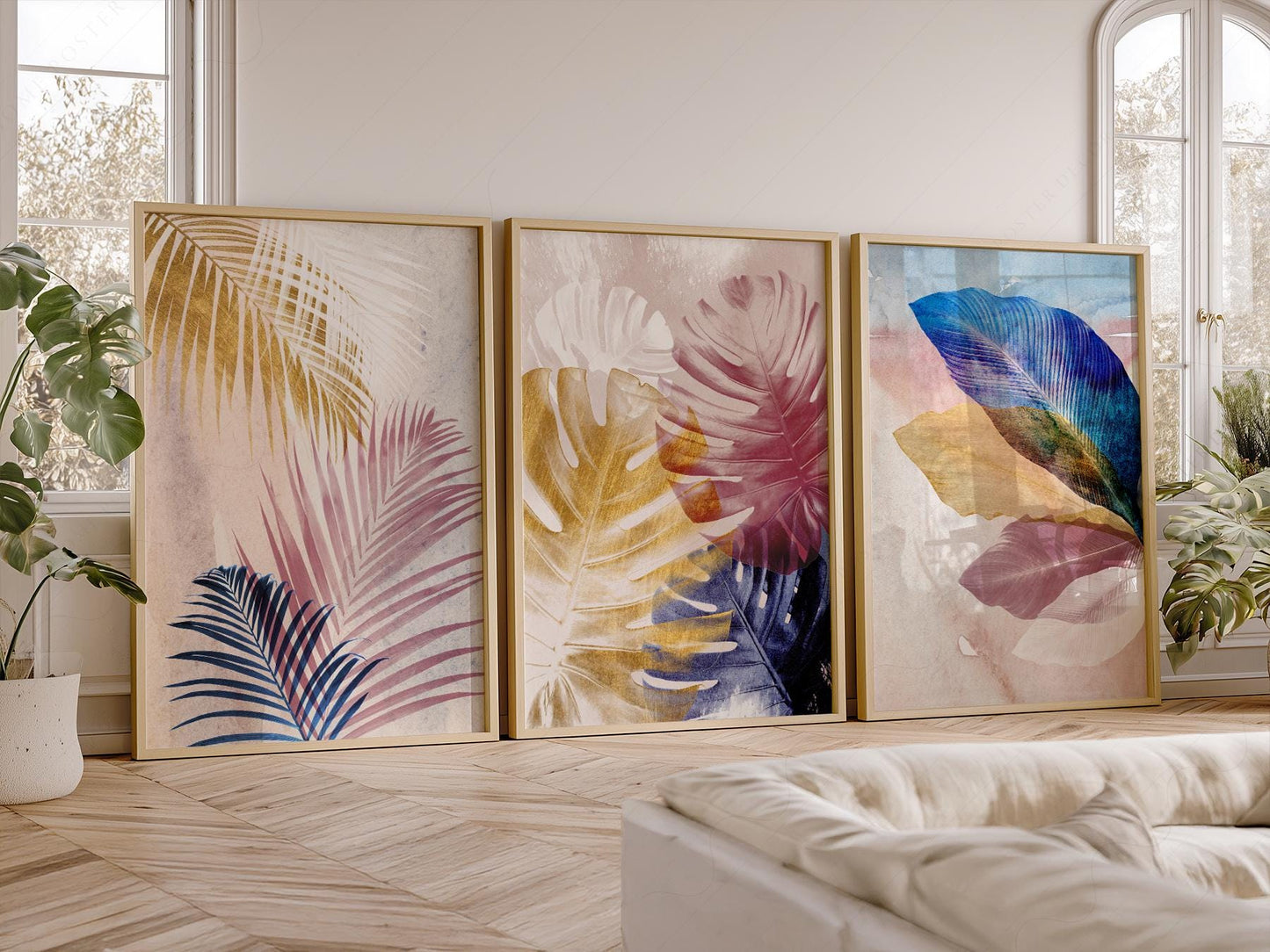 Set of three abstract tropical leaf art prints featuring palm fronds and monstera in pink, blue, and gold tones as wall art.