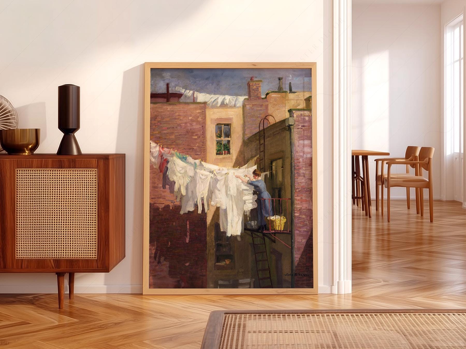 John Sloan A Woman's Work art print featuring a woman hanging laundry on a New York rooftop wall art.