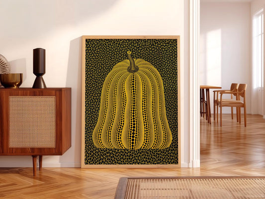 Yayoi Kusama pumpkin art print featuring yellow dotted pumpkin with black polka dots and geometric net background wall art.