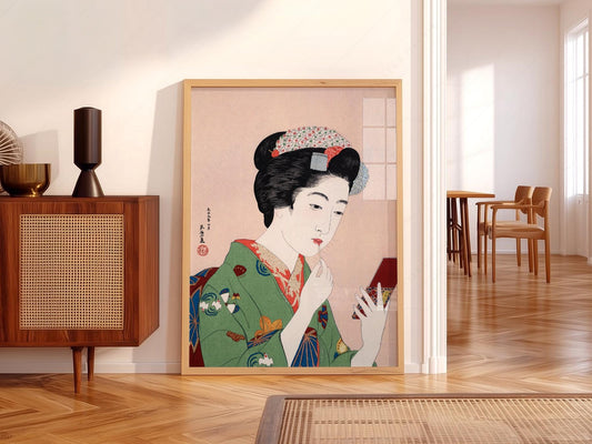 Goyo Hashiguchi ukiyo-e art print of a Japanese woman in green kimono applying lipstick while looking in a mirror.