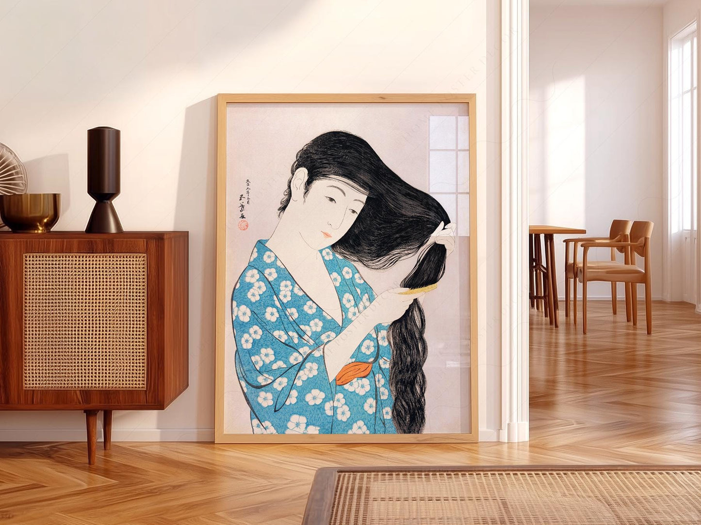 Hashiguchi Goyo Japanese woodblock art print of a woman in blue floral kimono combing her long black hair.