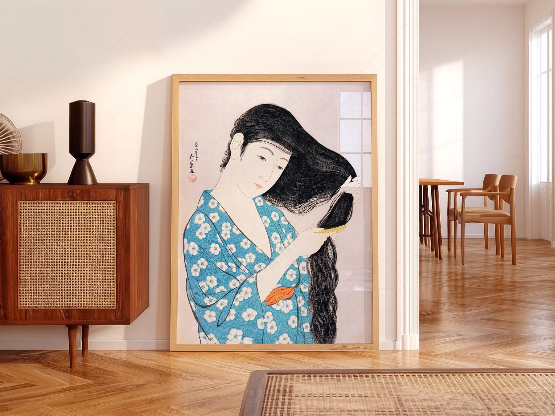 Hashiguchi Goyo Japanese woodblock art print of a woman in blue floral kimono combing her long black hair.